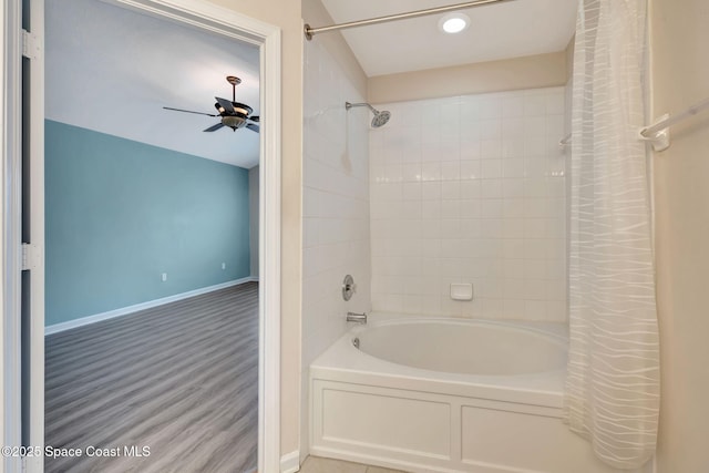 bathroom featuring ceiling fan, hardwood / wood-style flooring, and shower / tub combo with curtain