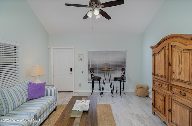 living room featuring vaulted ceiling, light hardwood / wood-style flooring, and ceiling fan