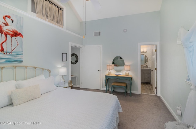 carpeted bedroom with ensuite bathroom, high vaulted ceiling, and ceiling fan