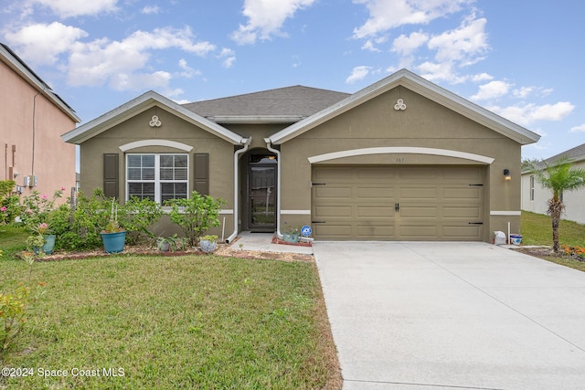 ranch-style house with a garage and a front yard