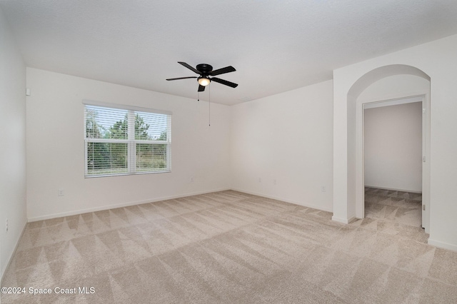 empty room with light carpet and ceiling fan