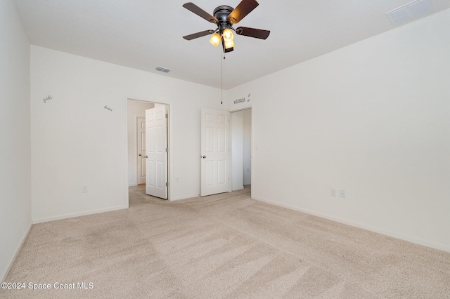 unfurnished room featuring light carpet and ceiling fan