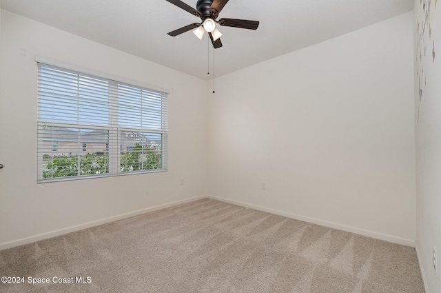 empty room featuring carpet flooring and ceiling fan