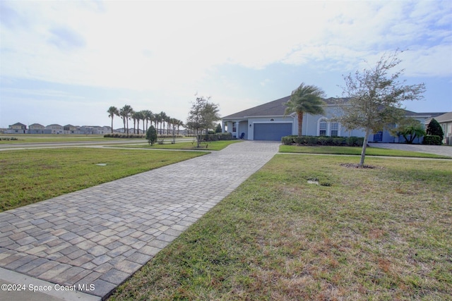 ranch-style home featuring a garage and a front lawn