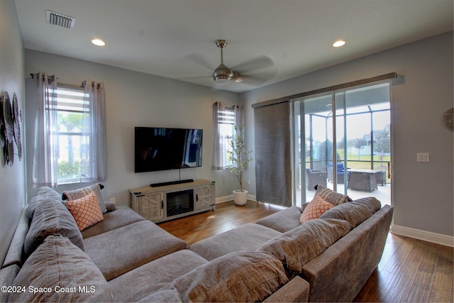 living room featuring ceiling fan and light wood-type flooring