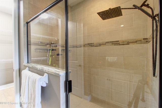 bathroom featuring a shower with door