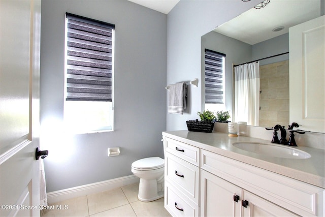 bathroom featuring toilet, vanity, and tile patterned floors