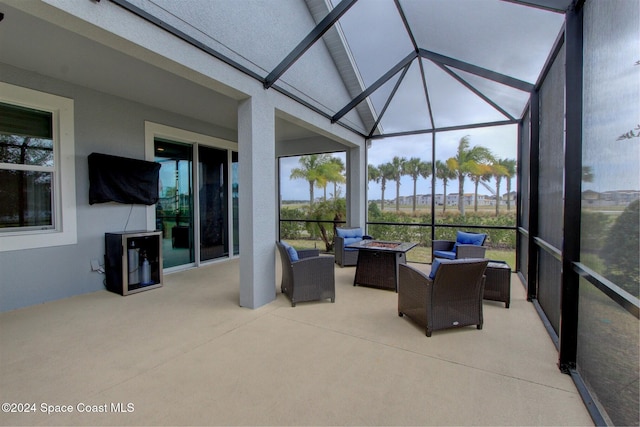 sunroom / solarium featuring plenty of natural light and vaulted ceiling