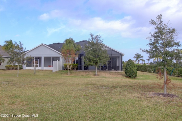 back of property featuring a yard and a lanai