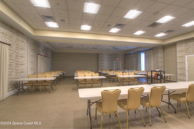 dining area featuring a paneled ceiling and carpet floors