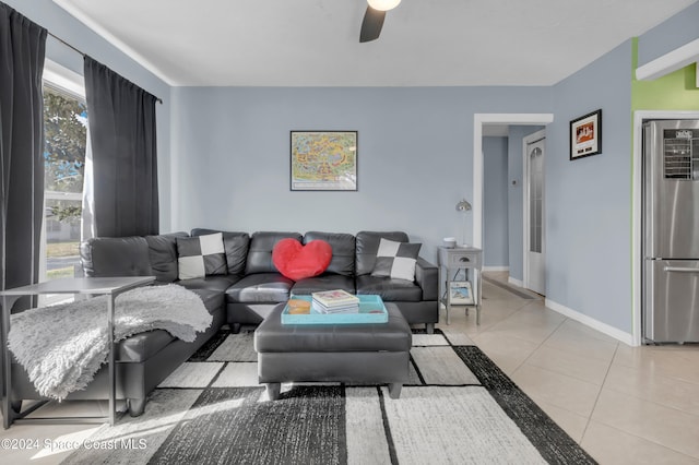 living room featuring ceiling fan and light tile patterned floors