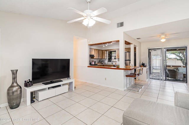 living room featuring ceiling fan and light tile patterned floors