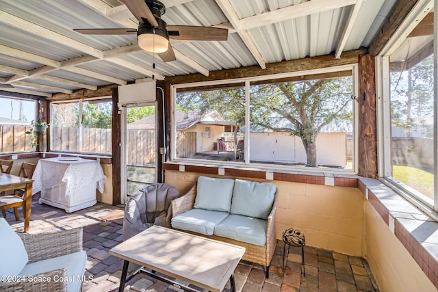 sunroom with beamed ceiling and ceiling fan