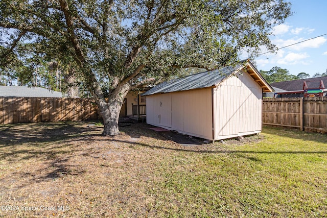 view of outbuilding featuring a lawn