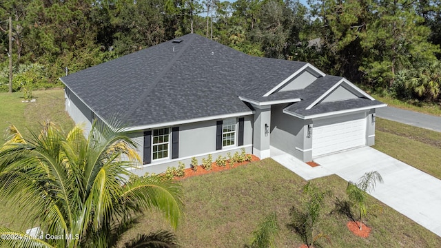 ranch-style house featuring roof with shingles, driveway, stucco siding, a front lawn, and a garage