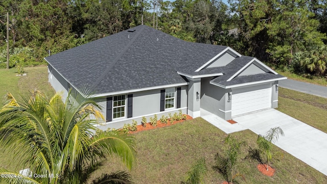 963 Sareta St SE, Palm Bay, FL 32909 - single story home featuring roof with shingles, a garage, concrete driveway, and a front lawn