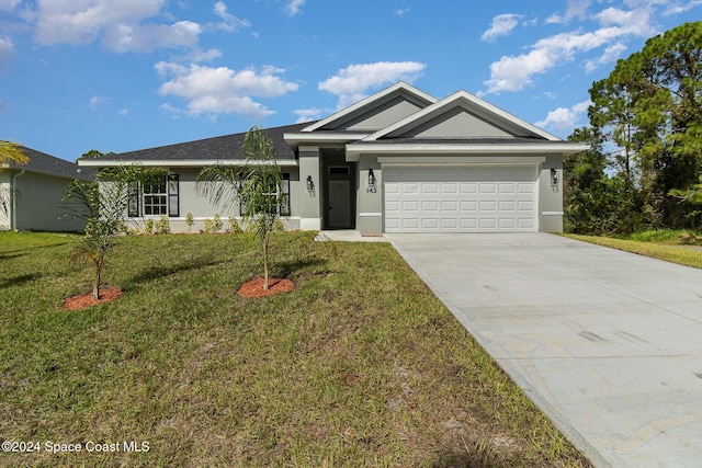 963 Sareta St SE, Palm Bay, FL 32909 - single story home with stucco siding, a front lawn, a garage, and driveway