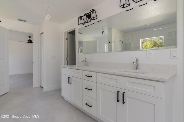 bathroom featuring a textured ceiling, vanity, ceiling fan, and a shower with shower door