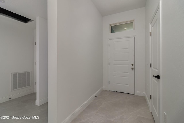 corridor featuring visible vents and baseboards