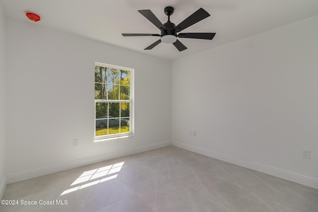 tiled empty room with ceiling fan