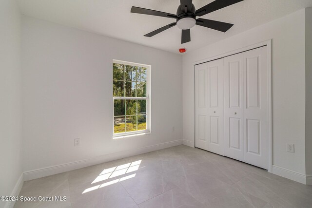 963 Sareta St SE, Palm Bay, FL 32909 - unfurnished bedroom with a closet and ceiling fan