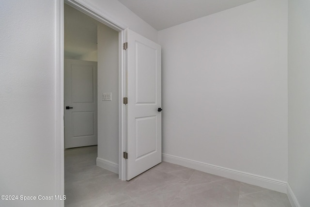 interior space featuring light tile patterned floors and baseboards