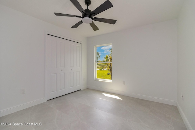 unfurnished bedroom featuring a closet and ceiling fan