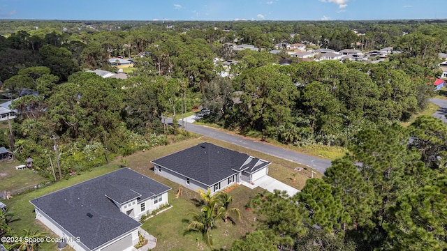 drone / aerial view featuring a wooded view