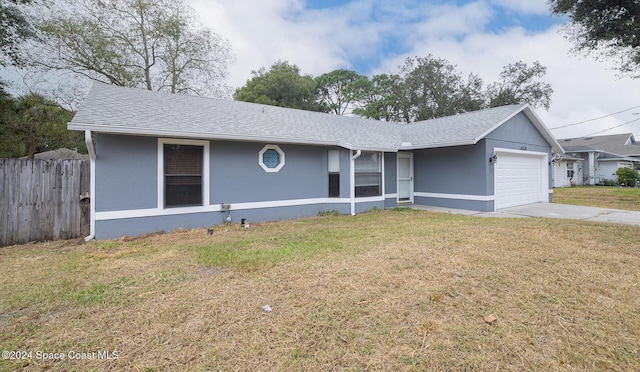 ranch-style home featuring a garage and a front lawn