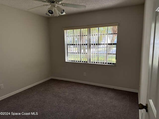 spare room with carpet, ceiling fan, and a textured ceiling