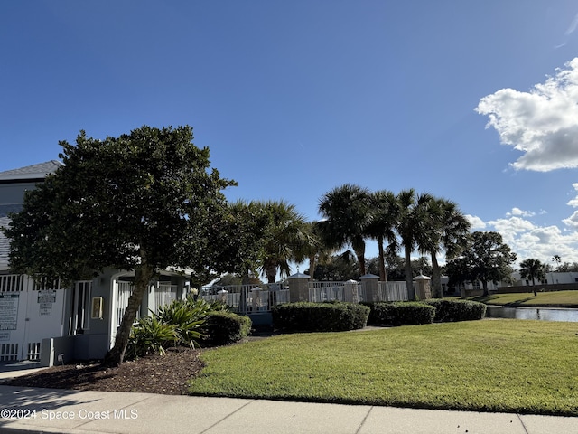 exterior space with a front lawn and a water view