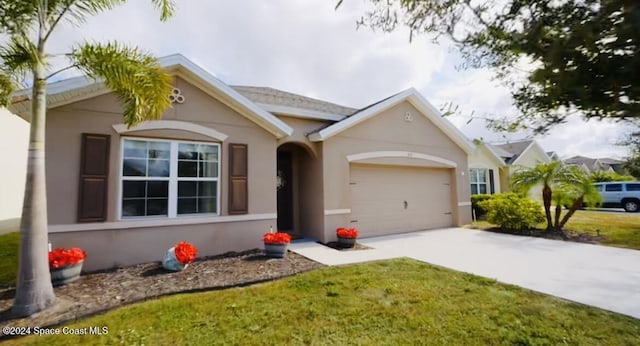 single story home with a garage and a front yard