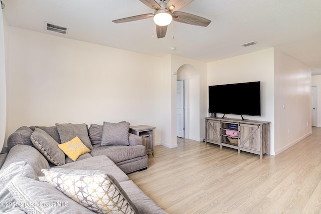 living room featuring light wood-type flooring and ceiling fan