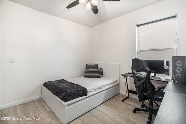 bedroom with ceiling fan and light wood-type flooring