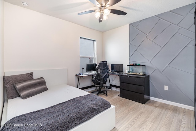 bedroom featuring light hardwood / wood-style floors and ceiling fan