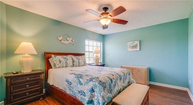 bedroom featuring a textured ceiling, dark hardwood / wood-style flooring, and ceiling fan