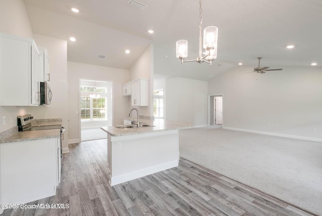 kitchen featuring electric range, white cabinets, lofted ceiling, and sink