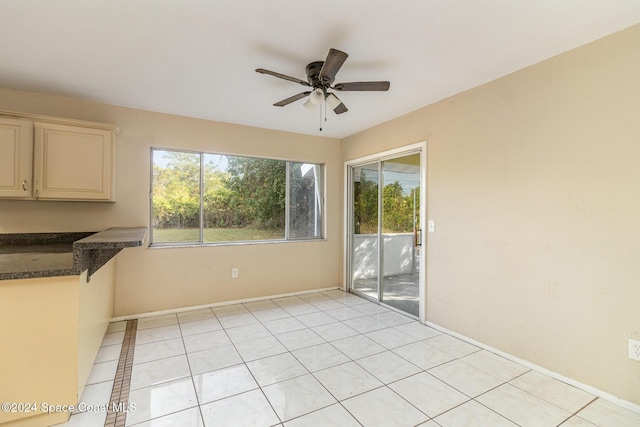 interior space with ceiling fan and light tile patterned flooring