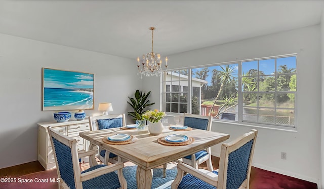 850 Cardinal Rd, Cocoa, FL 32926 - dining area featuring a chandelier and baseboards