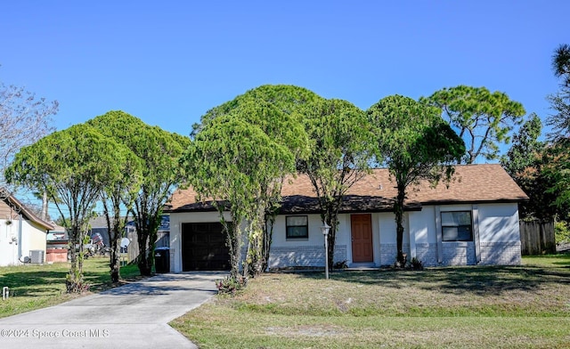 view of front of property featuring central air condition unit, a front yard, and a garage