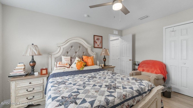 bedroom with a closet, ceiling fan, and light hardwood / wood-style flooring