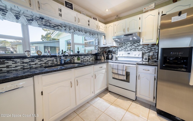 kitchen with decorative backsplash, white cabinetry, white appliances, and sink