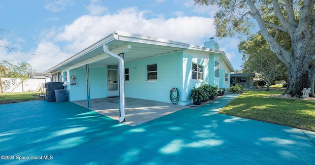 exterior space featuring a yard and a carport