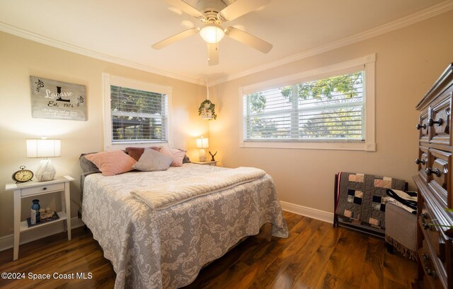 bedroom featuring ceiling fan, crown molding, dark wood-type flooring, and multiple windows