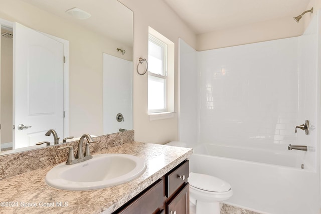 full bathroom featuring washtub / shower combination, vanity, and toilet