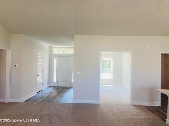698 De Groodt Rd SW, Palm Bay, FL 32908 - foyer with carpet floors, baseboards, and a chandelier