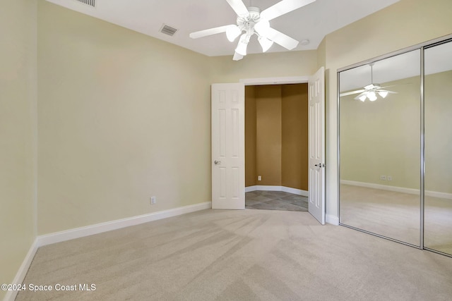 unfurnished bedroom featuring light colored carpet, a closet, and ceiling fan