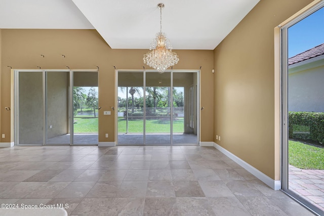 unfurnished room with a chandelier