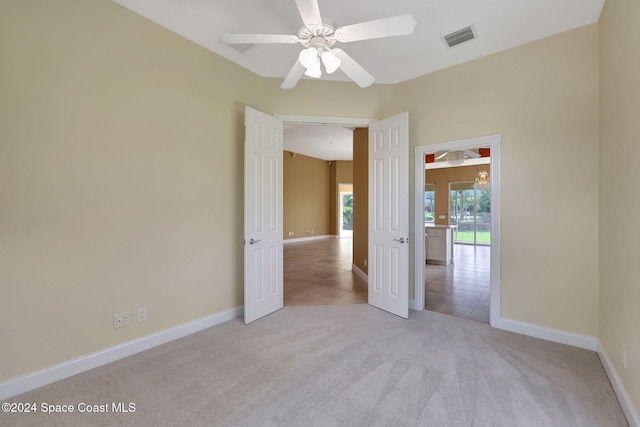 carpeted spare room with ceiling fan