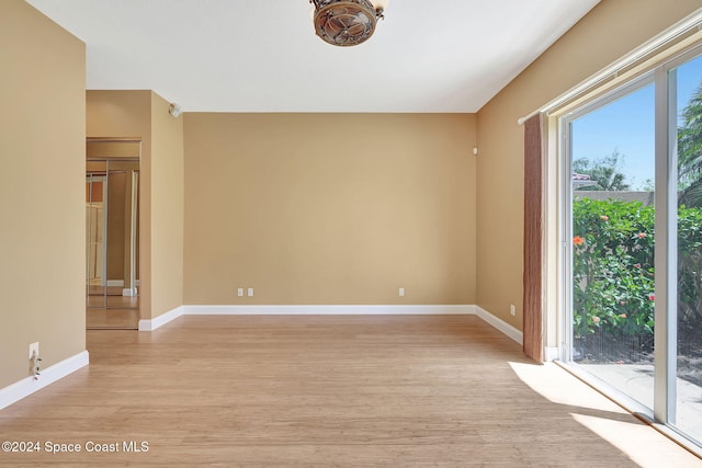 empty room with light hardwood / wood-style flooring